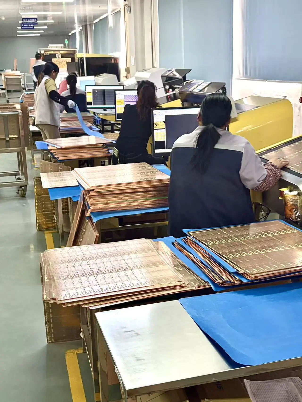 HXLFAB operators reviewing PCB production data at CAM workstations