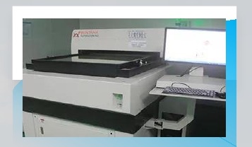 Company-supplied photograph of PCB hole-position measurement equipment